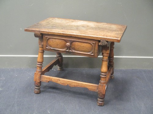 Lot 464 - A low oak table with single drawer on four...