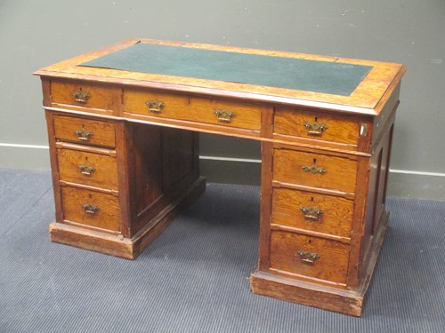 Lot 486 - An Edwardian pitch pine pedestal desk 137cm wide
