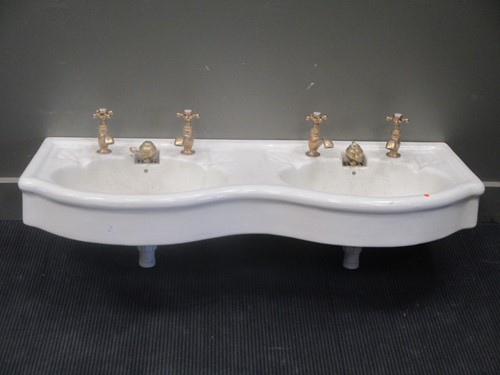 Lot 596 - A double sink with brass taps, 120cm wide