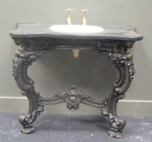 Lot 594 - A wash basin set into a serpentine marble...