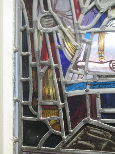 Lot 151 - A leaded stained glass panel of a medieval...