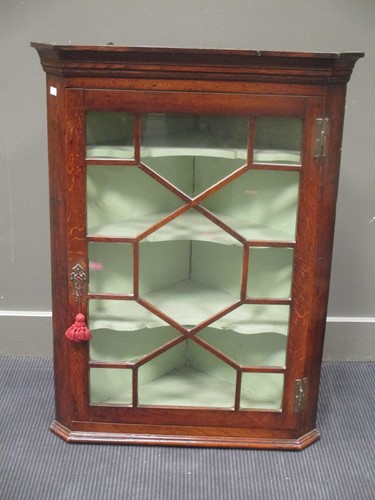 Lot 487 - A late Georgian provincial oak glazed hanging...