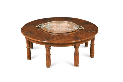 Lot 386 - A North African hardwood circular low dining table, late 19th / early 20th century