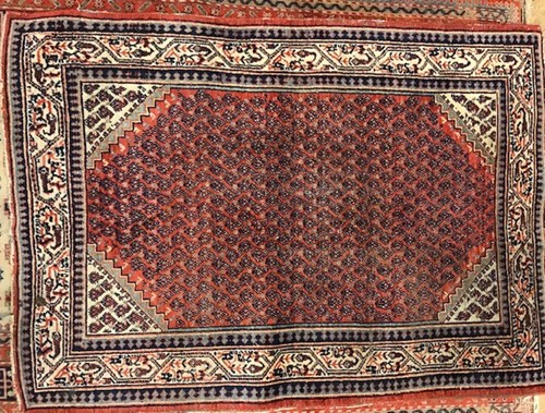 Lot 648 - A Sarab small red ground rug with multiple gul...