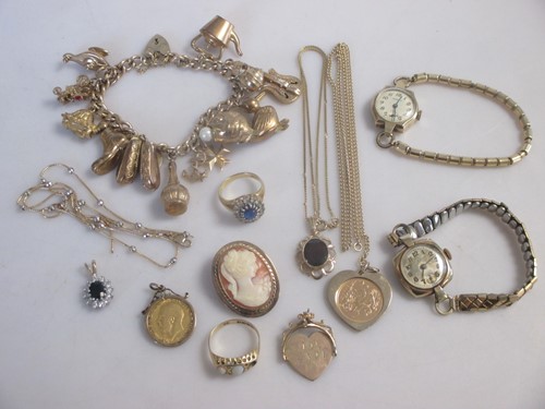 Lot 148 - A collection of gold, including a charm...
