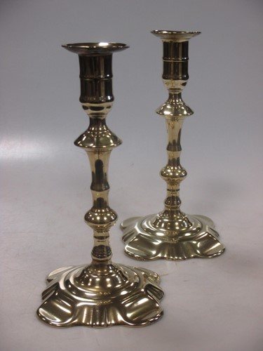 Lot 16 - A pair of Queen Anne brass candlesticks with...