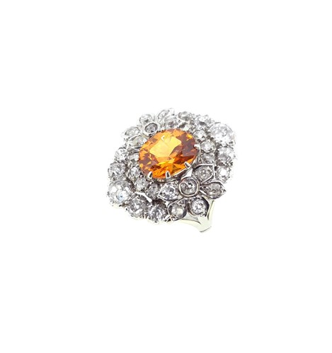 Lot 90 - An orange sapphire and diamond cluster ring