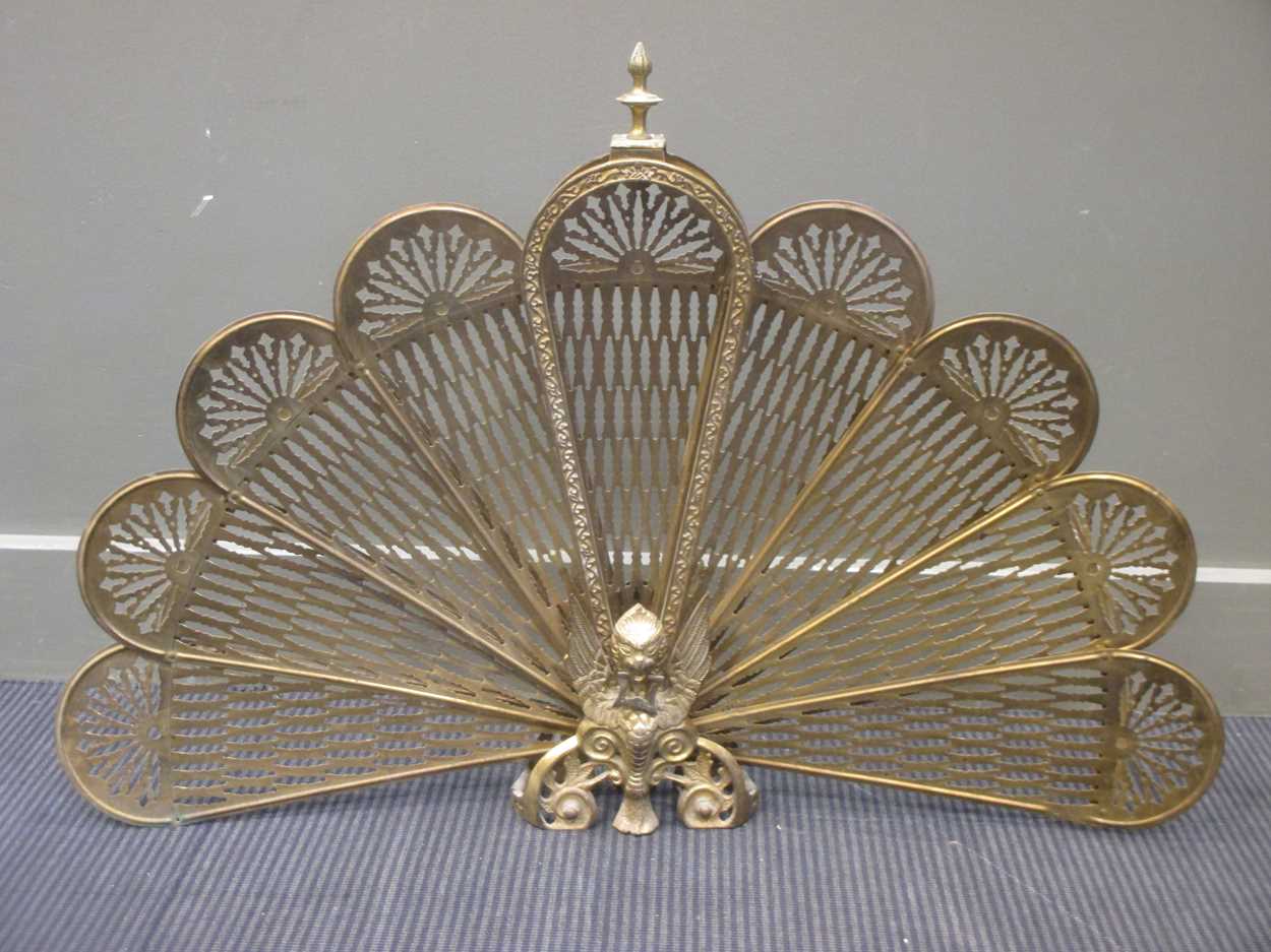 Lot 572 - A brass peacock tail fire screen, 63cm high