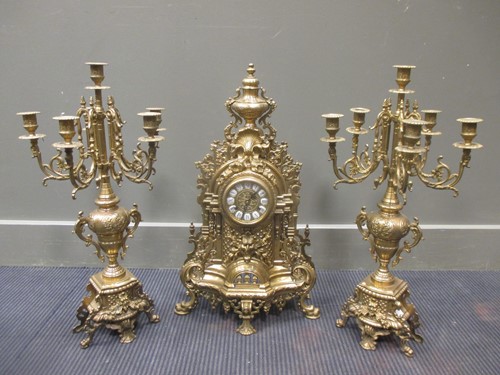 Lot 42 - A heavy brass clock garniture, 60cm high (3)