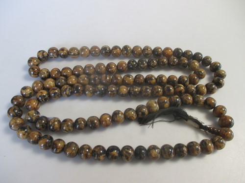 Lot 157 - A long row of amber beads, length 170cm,...