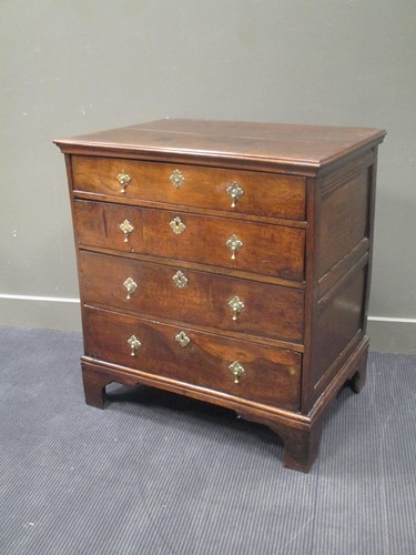 Lot 450 - An 18th century oak chest of four long...