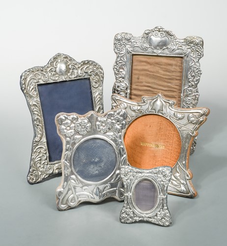 Lot 391 - Four early 20th century silver easel back photograph frames together with a later example