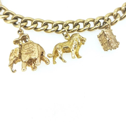 Lot 11 - A 9ct gold charm bracelet with many hallmarked charms