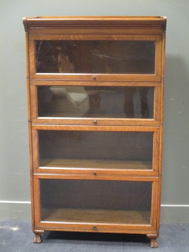 Lot 371 - A 20th century oak sectional bookcase...