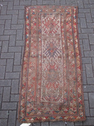 Lot 594 - A small tribal runner with 3 central...