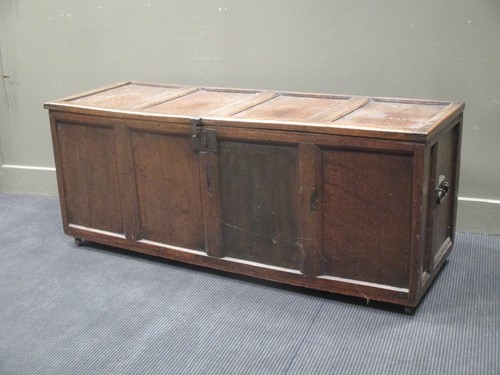 Lot 558 - An oak four panelled coffer with side handles...