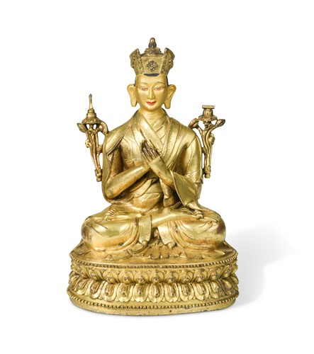 Lot 380 - A Tibetan or Mongolian gilt bronze lama