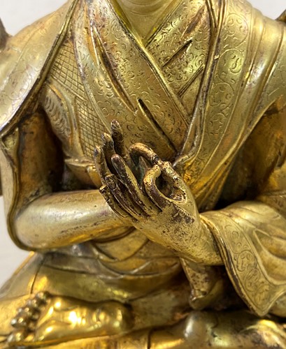 Lot 380 - A Tibetan or Mongolian gilt bronze lama