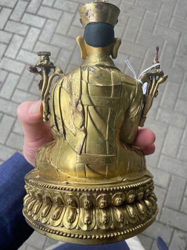 Lot 380 - A Tibetan or Mongolian gilt bronze lama
