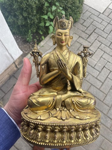 Lot 380 - A Tibetan or Mongolian gilt bronze lama