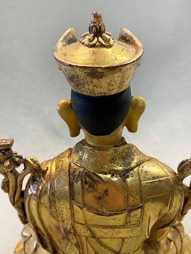 Lot 380 - A Tibetan or Mongolian gilt bronze lama