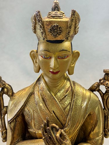 Lot 380 - A Tibetan or Mongolian gilt bronze lama