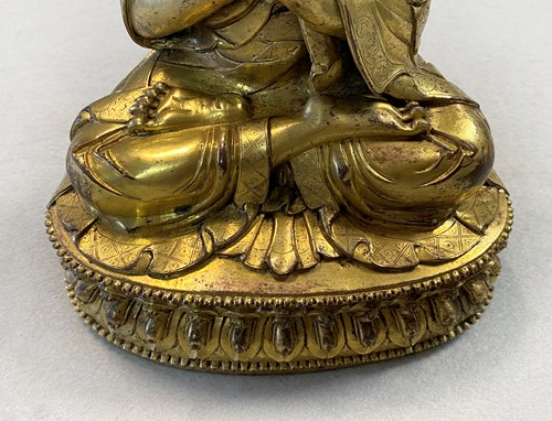 Lot 380 - A Tibetan or Mongolian gilt bronze lama