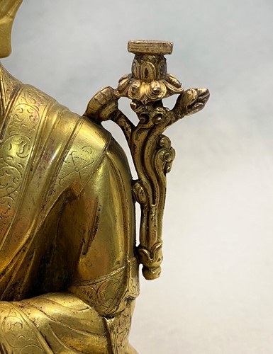 Lot 380 - A Tibetan or Mongolian gilt bronze lama