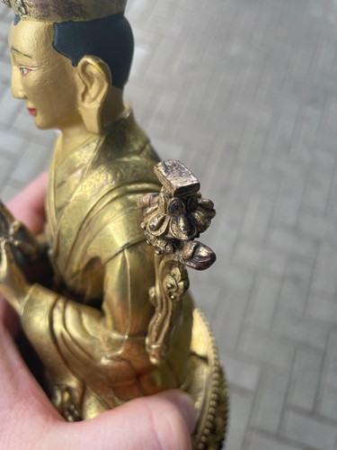 Lot 380 - A Tibetan or Mongolian gilt bronze lama