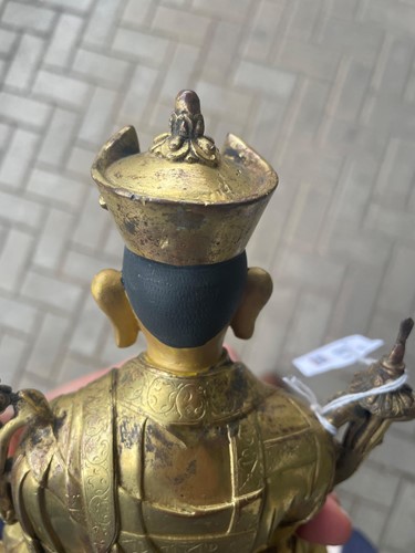 Lot 380 - A Tibetan or Mongolian gilt bronze lama