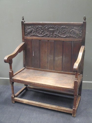 Lot 474 - An oak settle with carved frieze panel to back...