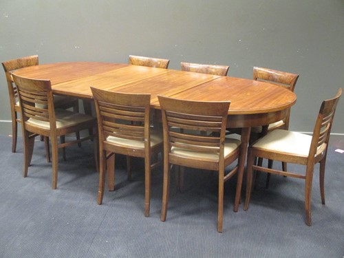 Lot 497 - An Art Deco style walnut extending dining...