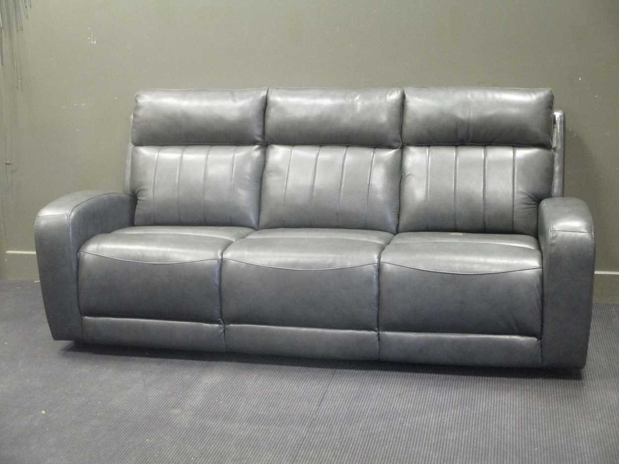 Lot 377 - A modern grey leather three seater sofa with