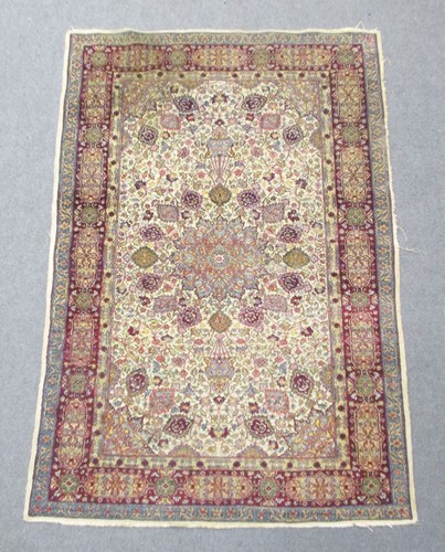 Lot 590 - A signed Kashan rug, with central medallion...
