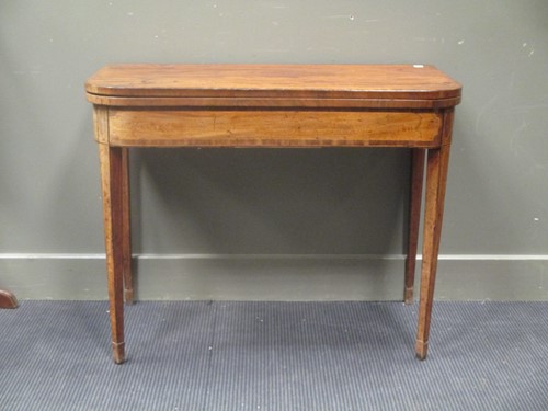 Lot 468 - A George III mahogany card table, on tapering...