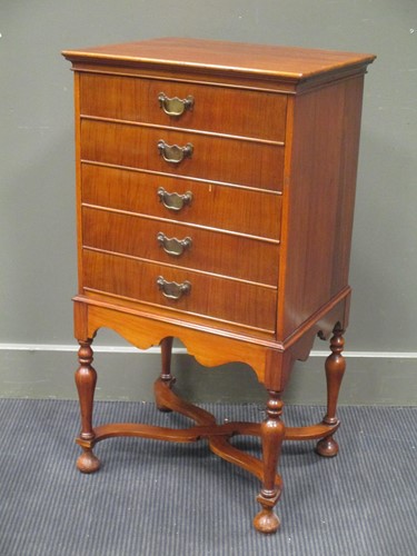 Lot 476 - A five drawer music cabinet, on turned legs,...