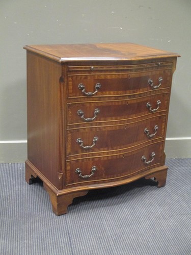 Lot 510 - A George III style serpentine chest of five...