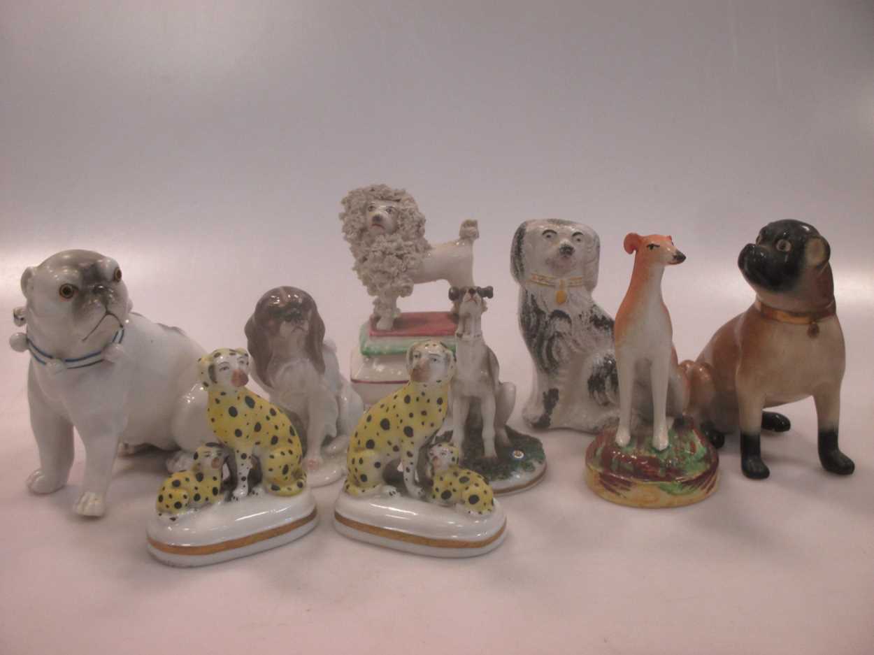 Lot 42 - A group of nine small ceramic model dogs,...