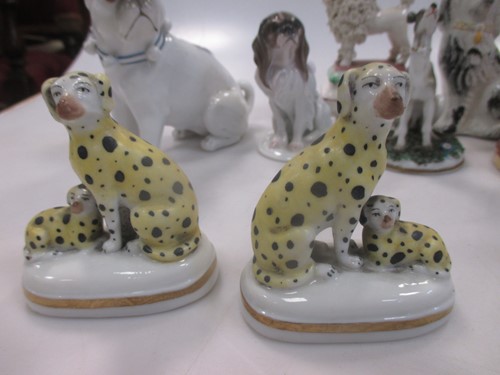 Lot 42 - A group of nine small ceramic model dogs,...