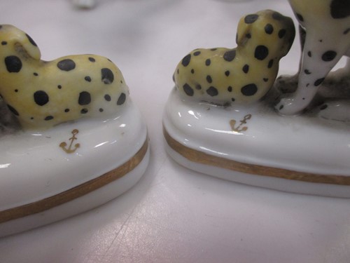 Lot 42 - A group of nine small ceramic model dogs,...