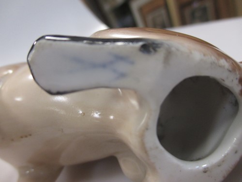 Lot 42 - A group of nine small ceramic model dogs,...