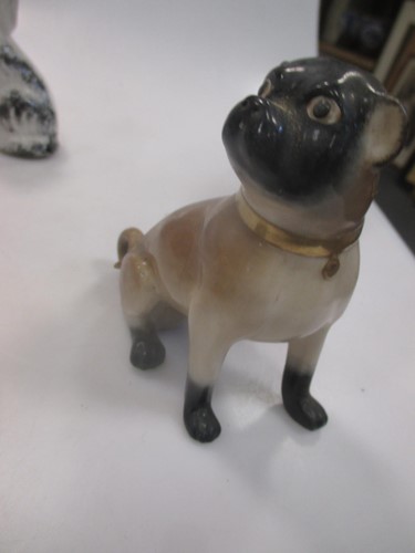 Lot 42 - A group of nine small ceramic model dogs,...