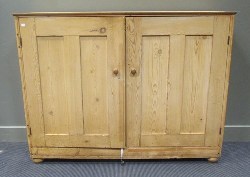 Lot 466 - A pine side cabinet enclosed by a pair of...