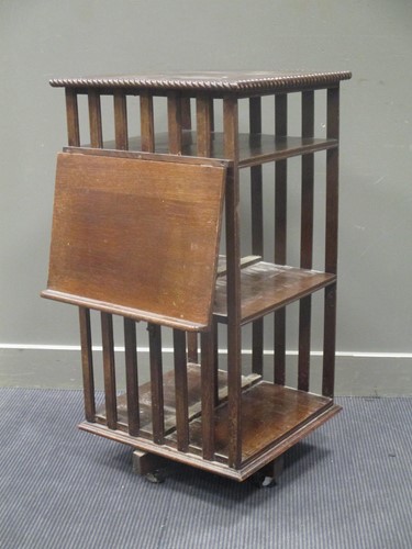 Lot 433 - An oak revolving bookcase with adjustable book...