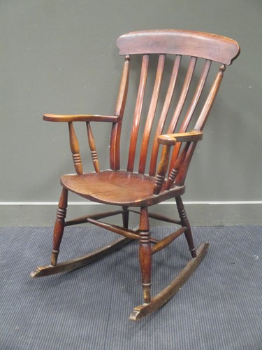 Lot 439 - A 20th century elm seated comb back rocking...
