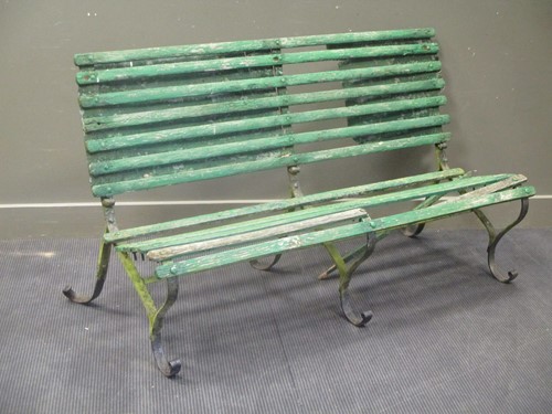 Lot 534 - A painted wood and wrought iron garden bench...