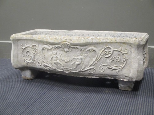 Lot 570 - A composite serpentine fronted garden planter...