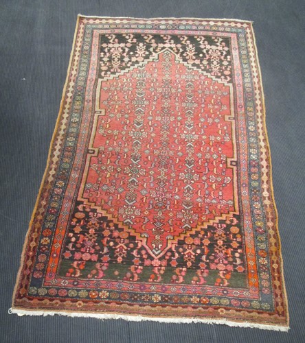 Lot 590A - A red ground rug, 221 x 127cm