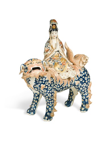 Lot 409 - A Japanese earthenware model of Kwannon upon the back of a shi-shi, late Meiji Period, circa 1900