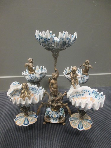 Lot 61 - A brass and porcelain centrepiece, the column...